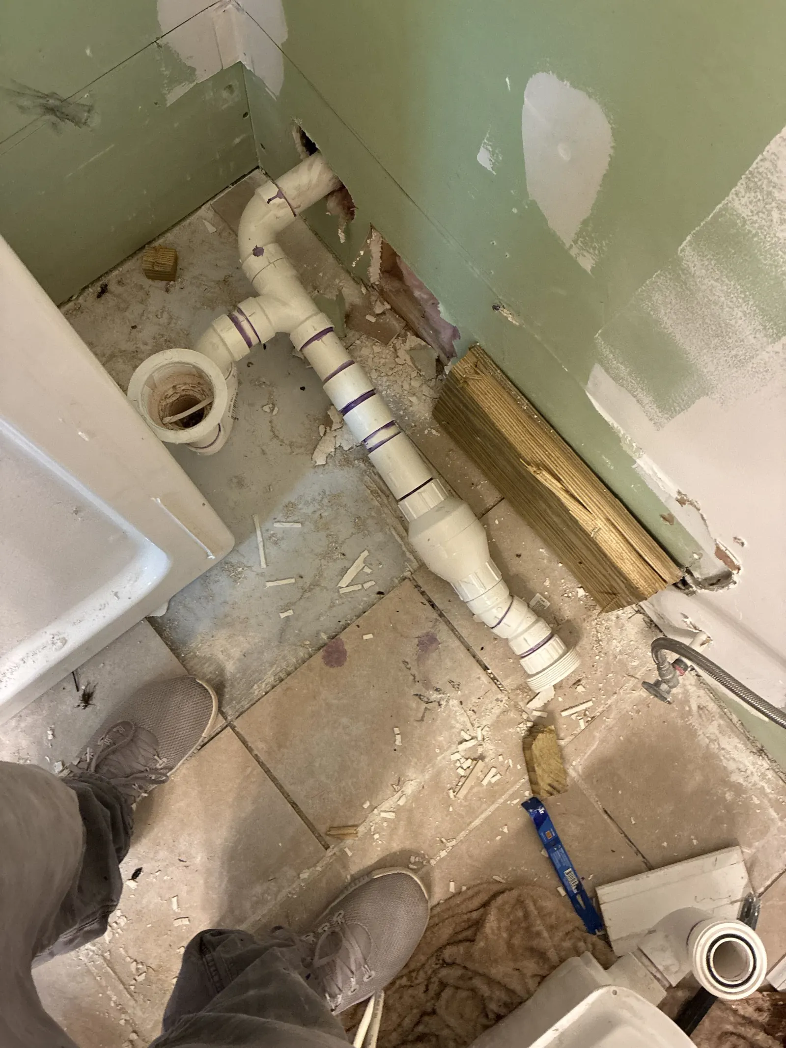 Drain line plumbing roughed in under a bathroom floor