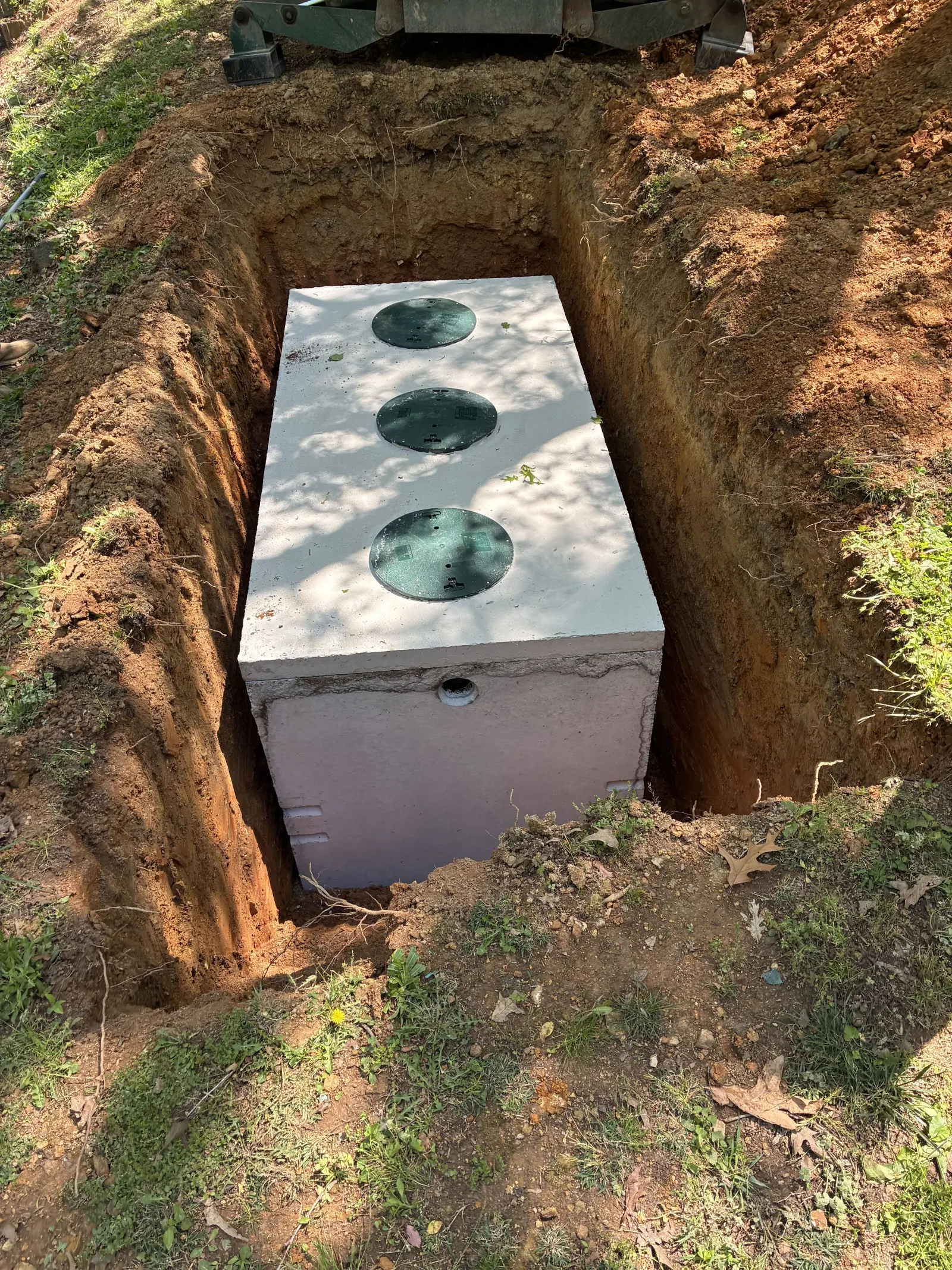 New precast concrete septic tank set level in the excavation
