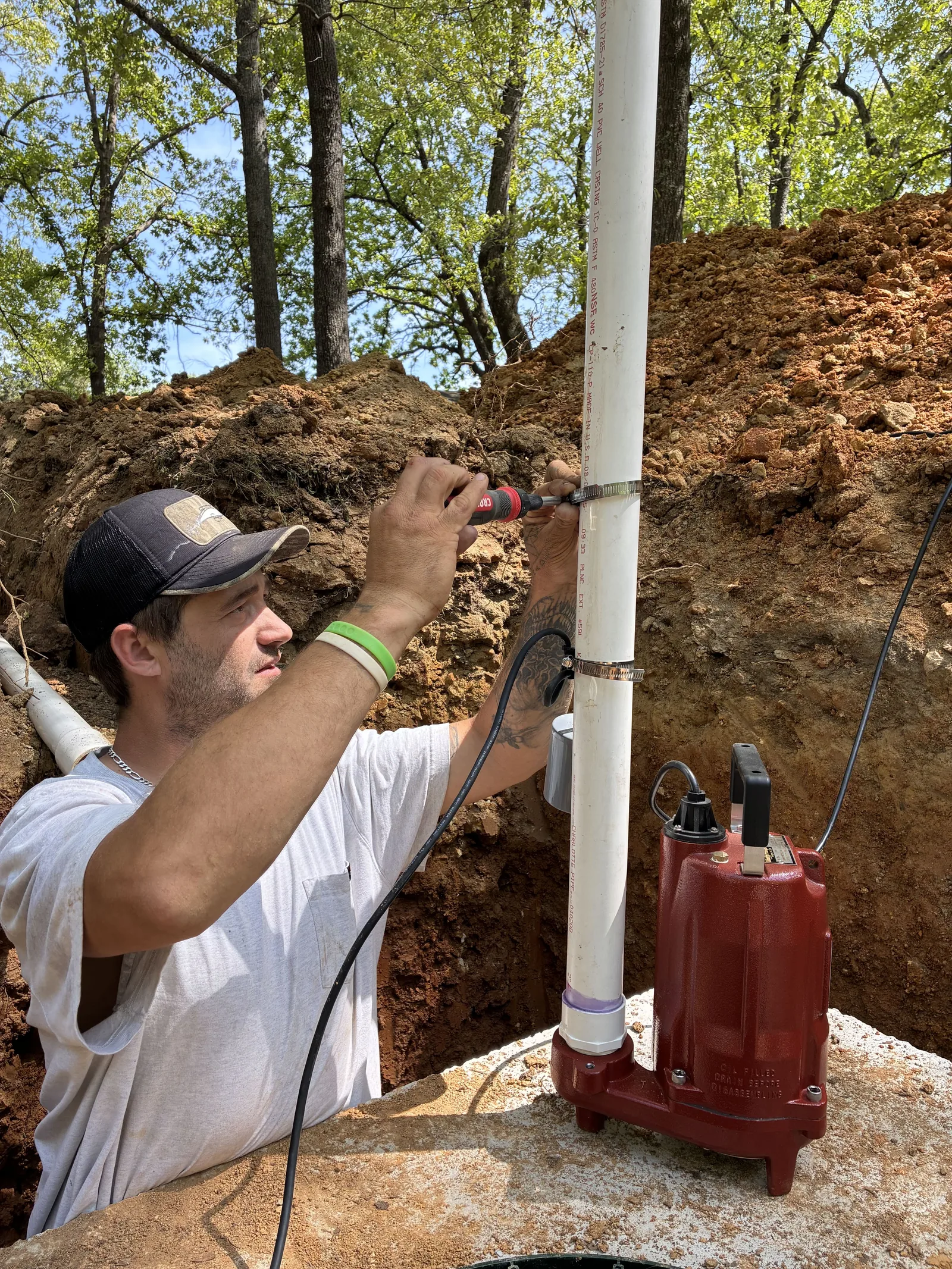 Technician connecting the discharge pipe on a new sewage pump