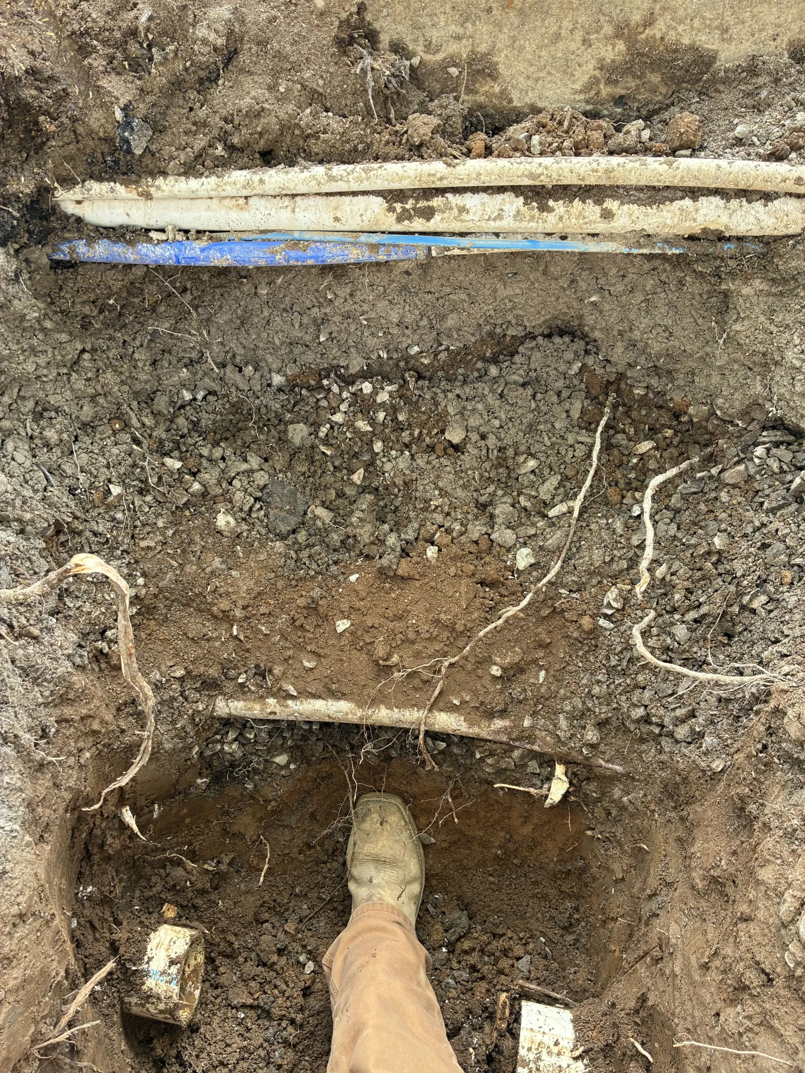 Checking pipe grade with a level in a sewer trench